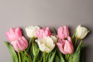 Beautiful tulips on gray background, space for text