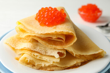 Plate of crepes with red caviar, close up
