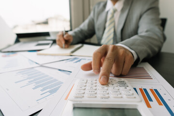 Business people work on the table to analyze financial budgets using a calculator To calculate numbers and liabilities Financial accounting concept