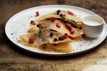 Crepes, apple pancake or caramelized apple crepe with yoghurt cream