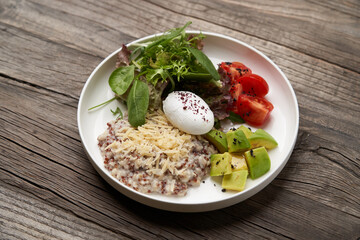 Quinoa porridge breakfast with oatmeal, poached egg