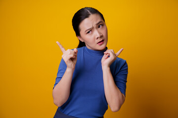 Confused Asian woman isolated on background.