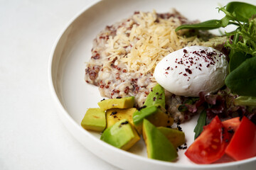 Quinoa porridge breakfast with oatmeal, poached egg