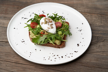 Poached egg toast with guacamole avocado sauce.