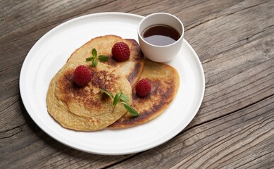 Healthy oat pancakes with raspberry berries and honey syrup