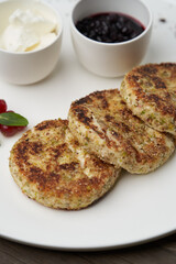 Cottage cheese pancakes with berry jam and sour cream