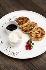Cottage cheese pancakes with berry jam and sour cream