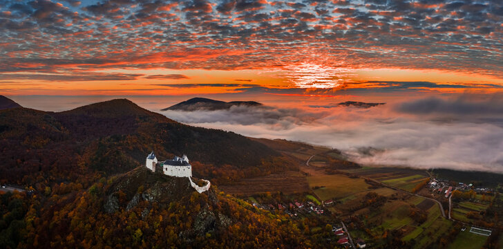 Fuzer, Hungary - Aerial panoramic view of the beautiful Castle of Fuzer with amazing colorful sunrise sky and clouds on an autumn morning. The castle has been located in the mountains of Zemplen