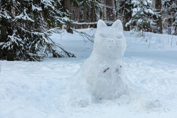 Obraz na płótnie Canvas big cat made of snow in the forest.