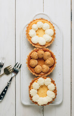 Mini New York Cheesecakes on wooden table. Top view