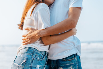 romantic couple hug together on the beach at summer. Honeymoon, travel, holiday, summer concept.