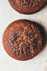 Two healthy brown sugar cinnamon cake on textured natural stone background. The image shows crumbs and texture.