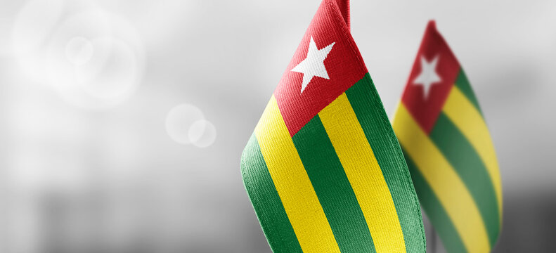 Small National Flags Of The Togo On A Light Blurry Background