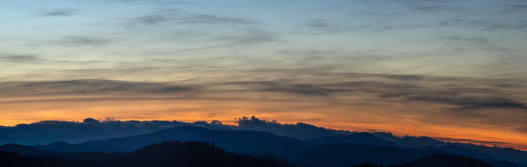 Naklejka na ściany i meble Sunset panorama on a winter evening in the Carpathian region