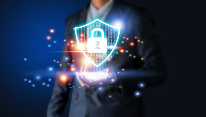 Businessman's hand holding virtual screen padlock and cloud computing global network cyber security data protection business technology privacy concept.