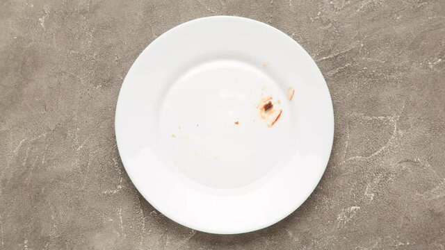 Hamburger on white plate. Delicious burger eating animation, stop motion. Fast food concept