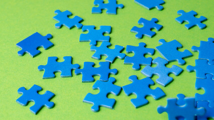 scattered puzzle pieces on colored background