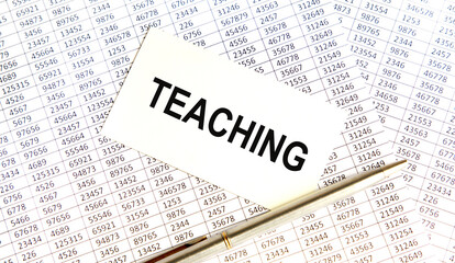 Obraz premium On the card text Teaching, next to the pen, the background are the rules.