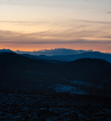 Panorama of the silhouette of mountains and forest on the background of sunset