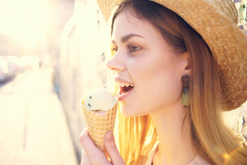 woman with ice cream in her hands walking around the city sunny day