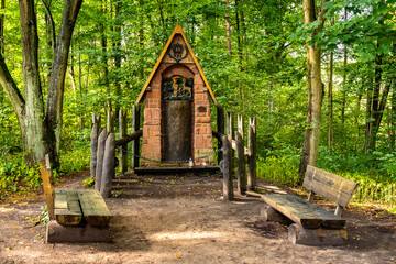 Traditional wooden shrine besides Bartek Oak nature monument in Swietokrzyskie Mountains village Zagnansk near Kielce in Poland