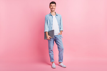 Full length body size photo of positive programmer holding computer wearing casual clothes isolated...