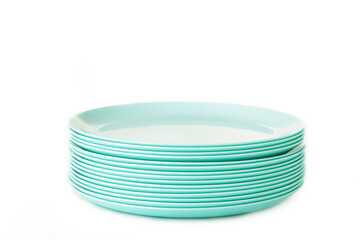 Set of stacked mint ceramic plates isolated on white background.
