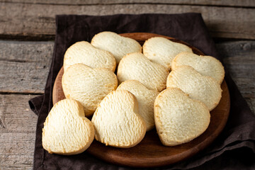 Lemon cookies. Lemon cookie hearts on a round serving board on a brown wooden table. Cookies for Valentine's Day