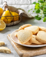 Lemon cookies. Lemon Heart cookies in a white plate on the light gray kitchen table. Cookies for Valentine's Day