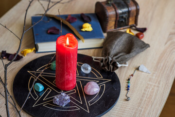Altar with a pentagram to attract love, happiness, candle, stones, Tarot cards and witchcraft at...