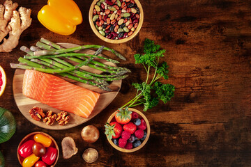 Healthy diet, top shot with a place for text, on a dark rustic wooden background
