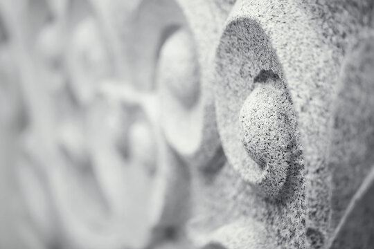 Traditional granite stone curve sculpture.Oriental style in.monochrome for background,very shallow depth of field and selective focus.