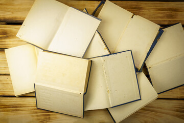 Top view of blank open books on wood background. Background from many books. World Book and Copyright Day.