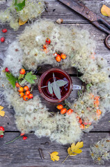 a cup of tea and an autumn wreath of dried flowers