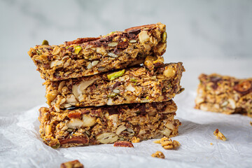 Homemade oat bars with berries and nuts, light background. Energy Protein Healthy Bars. Vegan...