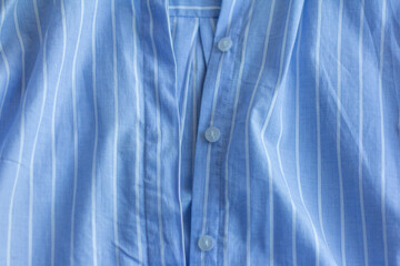 A fragment of a cotton shirt with the buttons undone.Textile background.