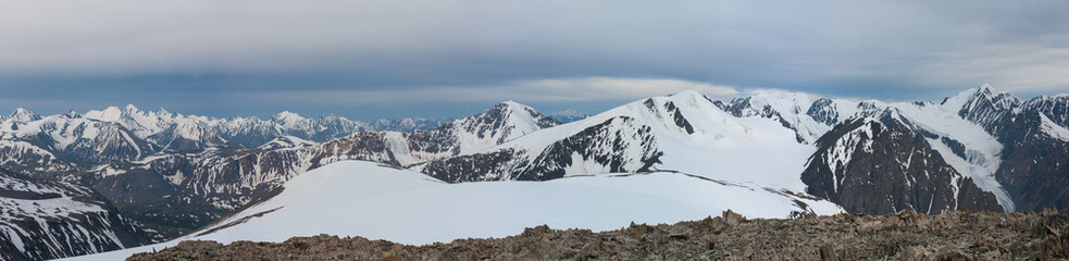 Fototapeta na wymiar Panoramic mountain view. Snow-capped peaks and glaciers.