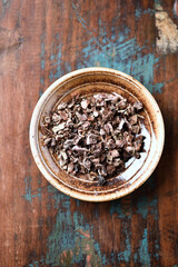 Dry root of Rhodiola rosea. Golden root, rose root. Healthy medical plant on wooden background. Top view. Close up. 
