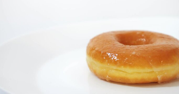 Tasty sweet glazed donuts on white background.