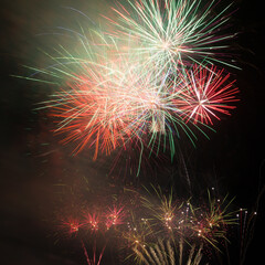 Colorful fireworks display on night sky background.