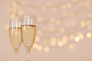 Two glasses of wine with bokeh background close up. Top view. New Year, Christmas mood. Greeting card. Party and holiday celebration concept.