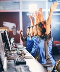 Winning. Young multiracial team of happy professional cyber sport gamers celebrating success, raising hands up while participating in eSports tournament © Friends Stock