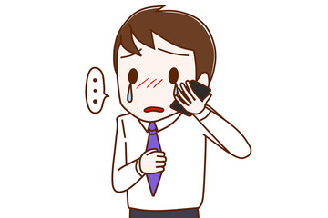 スマホで涙を流しながら悲しそうに話す男性