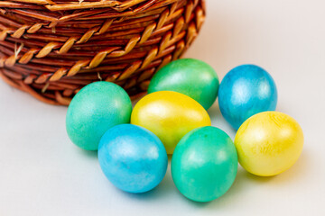 Painted colorful Easter eggs with fluffy and basket.