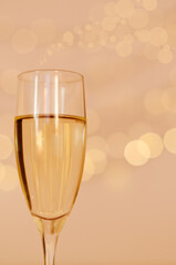 Glass of wine with bokeh background close up. Flat lay. New Year, Christmas mood. Greeting card. Party and holiday celebration concept.
