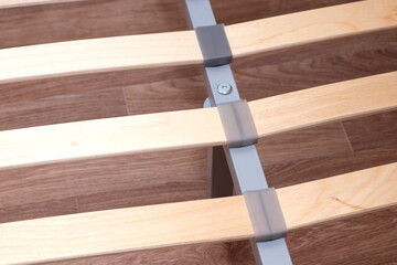 Closeup of wooden slats of a double bed. Birchen an arthopedic base of a bed.