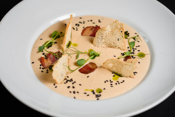 Pureed bacon soup in a white plate