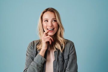 Cheerful beautiful blonde girl smiling and looking aside