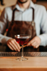 Red alcoholic cocktail on the bar counter