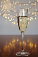 glass of wine with bokeh background close up. Top view. New Year, Christmas mood. Greeting card. Party and holiday celebration concept.